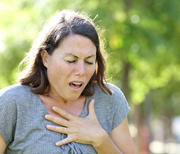 woman holding her chest